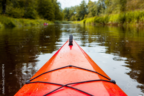 Kayaking, canoeing on the river in the middle of the summer. Sports, leisure and recreation in the wild nature.