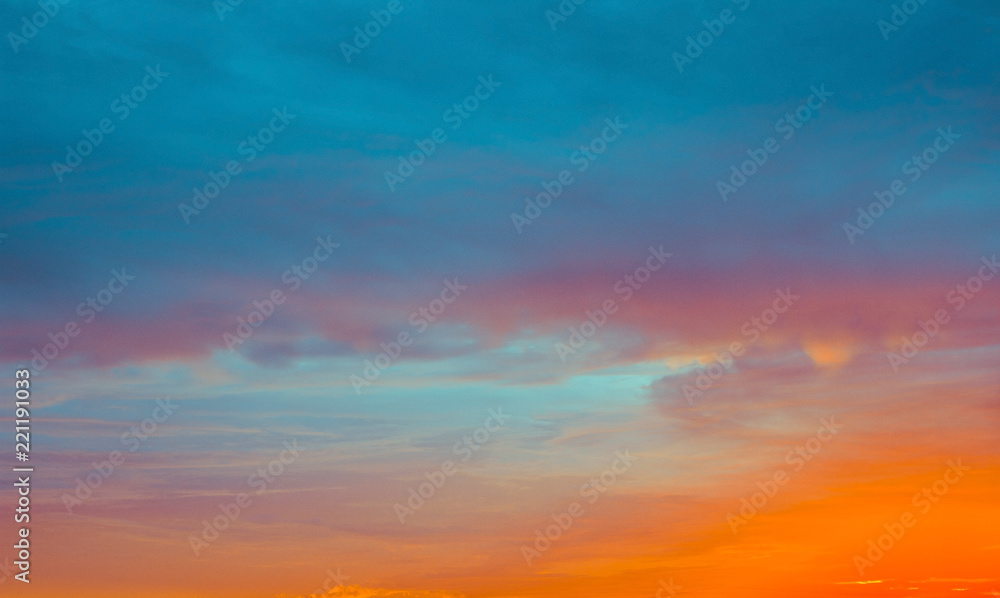 blue and orange sky clouds at sunset or sunrise.