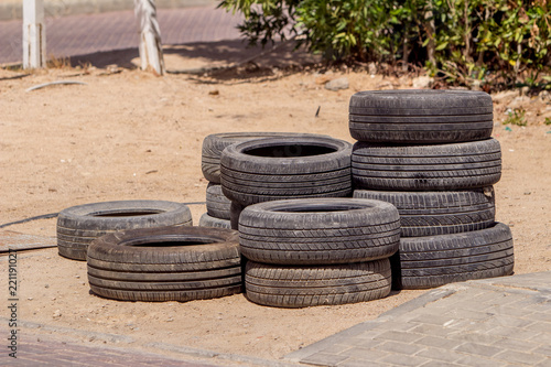 Old tires on the sand.