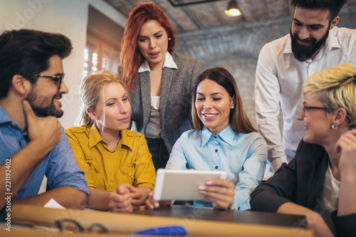  Group of young business people in smart casual wear working together in creative office