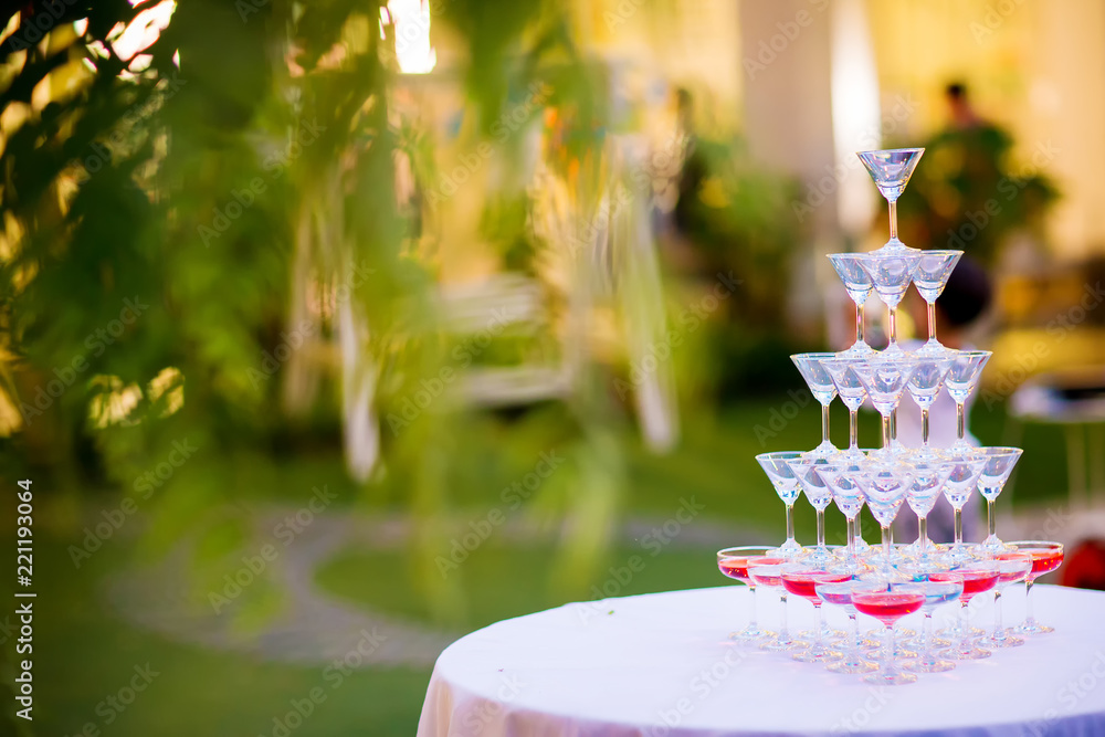 Fototapeta premium Champagne glass pyramid.pyramid of glasses of wine, champagne, tower of champagne's glass in wedding reception party