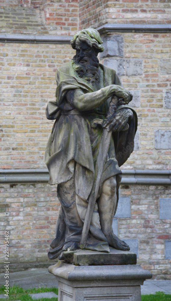 Statue in front of church of Our Lady in Bruges, Belgium