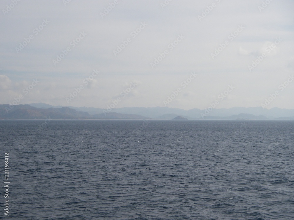 Obraz premium View on the green moutain, from the blue sea