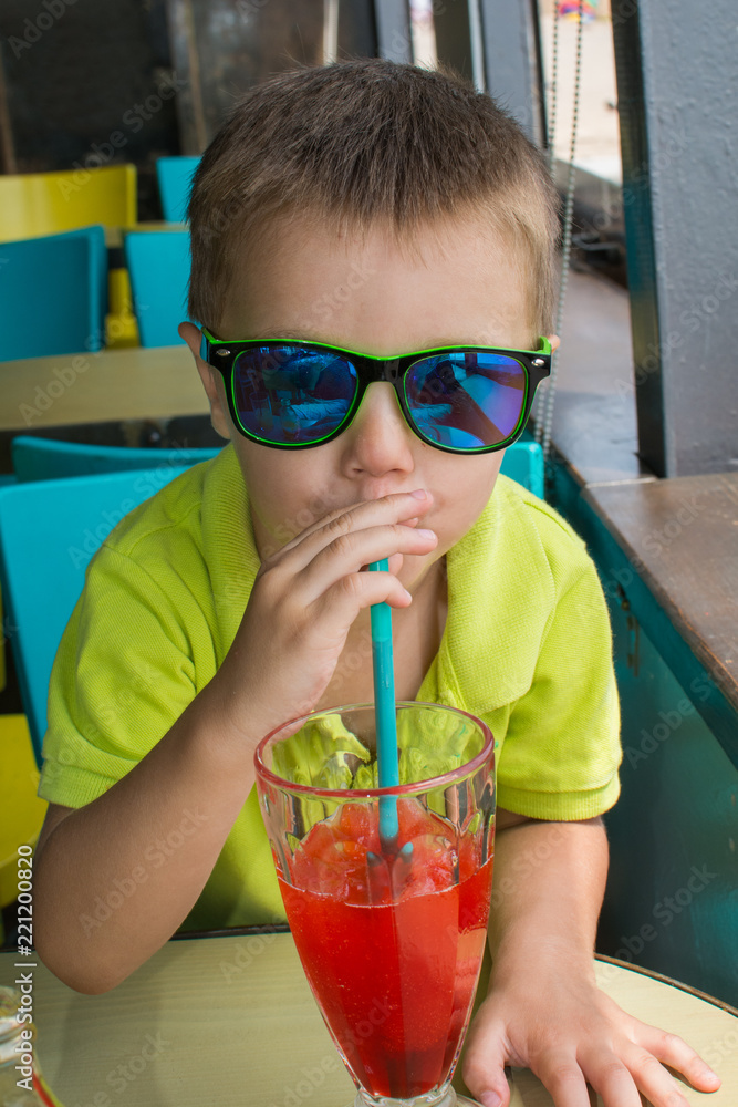 Funny boy eating a strawberry cocktail Funny boy eating a strawberry cocktail