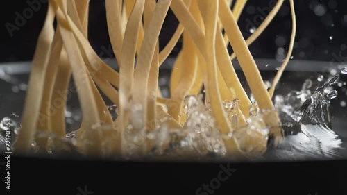 Throwing linguine noodle in water. Shot with high speed camera, phantom flex 4K. Slow Motion.