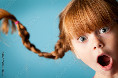 Little Girl Gasping with Surprise, Isolated on Teal
