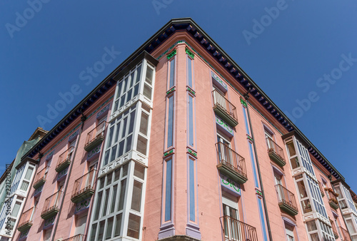 Historic facade of a pink corner building in Burgos, Spain