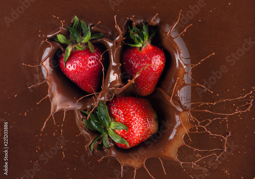 close up of strawberries in chocolate splash