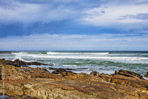 Picturesque view of the rocky shoreline of Atlantic Ocean and Platboom Beach. Platboom Bay is a beautiful beach along coastline nestled in Cape of Good Hope Nature reserve, Cape Town, South Africa.