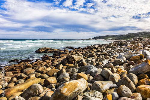Picturesque view of the rocky shoreline of Atlantic Ocean and Platboom Beach. Platboom Bay is a beautiful beach along coastline nestled in Cape of Good Hope Nature reserve, Cape Town, South Africa.