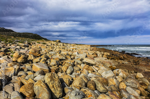 Picturesque view of the rocky shoreline of Atlantic Ocean and Platboom Beach. Platboom Bay is a beautiful beach along coastline nestled in Cape of Good Hope Nature reserve, Cape Town, South Africa.