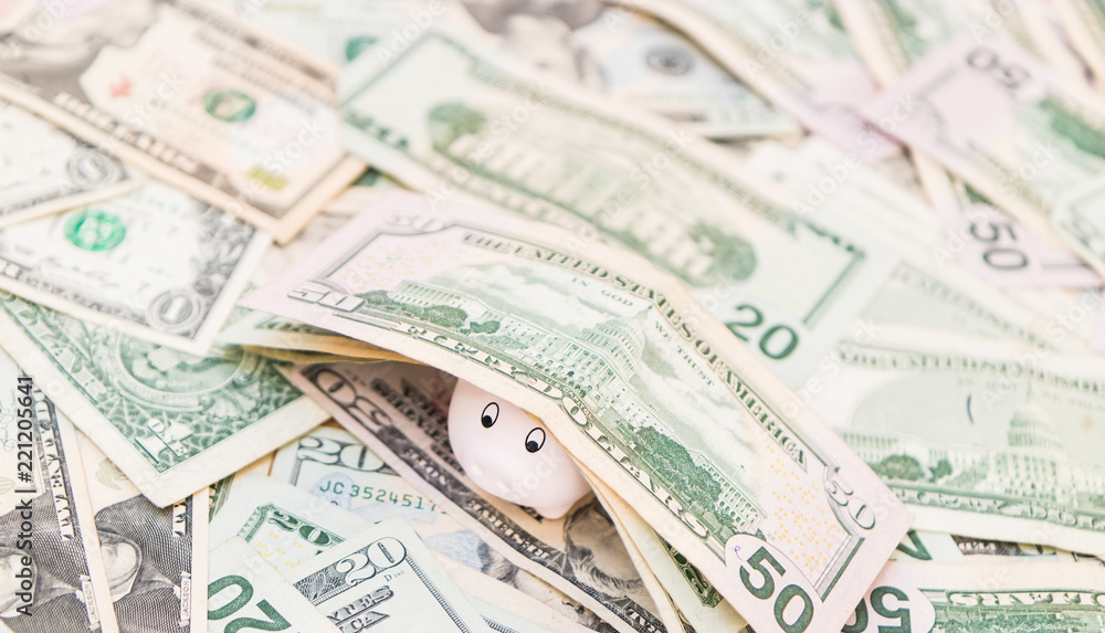 Piggy bank with a lot of American Dollars; investment and banking concepts Piggy bank with a lot of American Dollars; investment and banking concepts