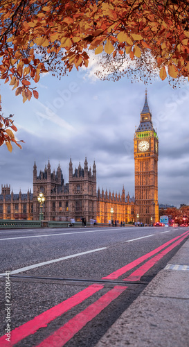 Buses with autumn leaves against Big Ben in London  England  UK