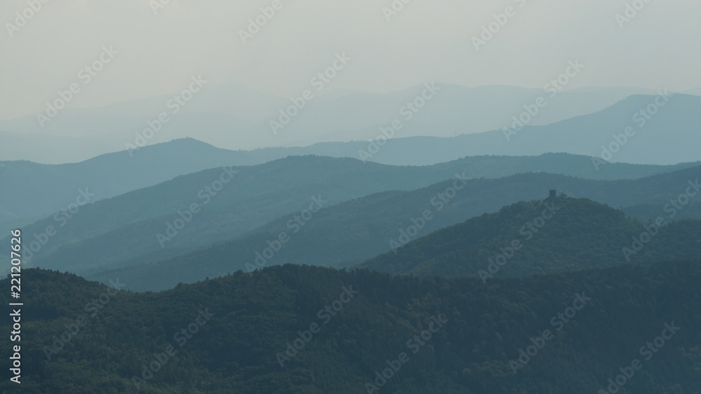 Abstract Landscape with Silhouettes of Misty Mountains and Forest. Multilevel Mountain Range in the Background and a Dense Forest in the Foreground