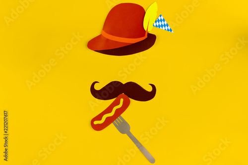Germany face silhouette with bavarian brown hat, mustache eating sousage with mustard on fork. Ads event of october beer festival in autumn october month photo