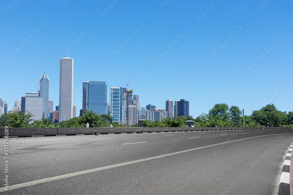 asphalt highway with modern city in chicago asphalt highway with modern city in chicago