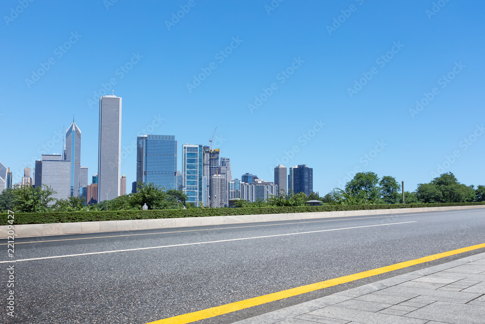 asphalt highway with modern city in chicago asphalt highway with modern city in chicago