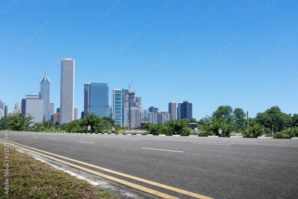 asphalt highway with modern city in chicago asphalt highway with modern city in chicago