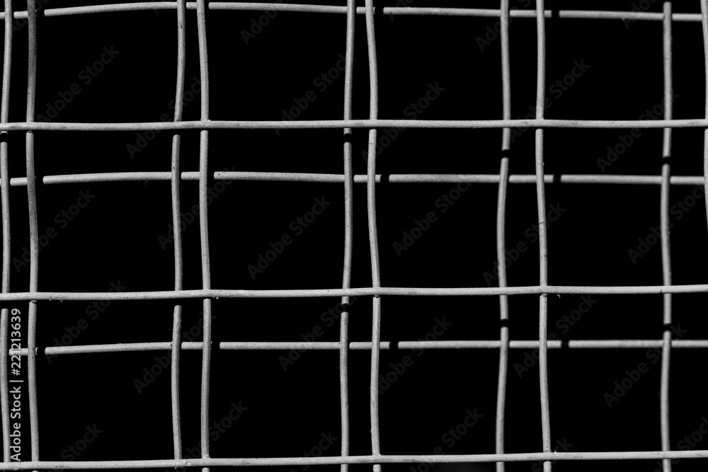old square metal mesh on a black background old square metal mesh on a black background