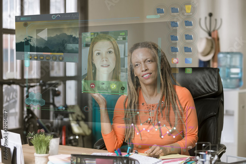 Smiling Professional Woman Viewing Call on a Futuristic Computer Screen