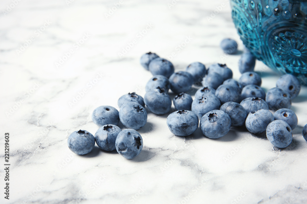 Fresh and juicy blueberries on marble table Fresh and juicy blueberries on marble table