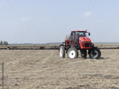 Exhibition of agricultural machinery. Agrotechnics works in the field. The tractor lights the field. Irrigation machine.