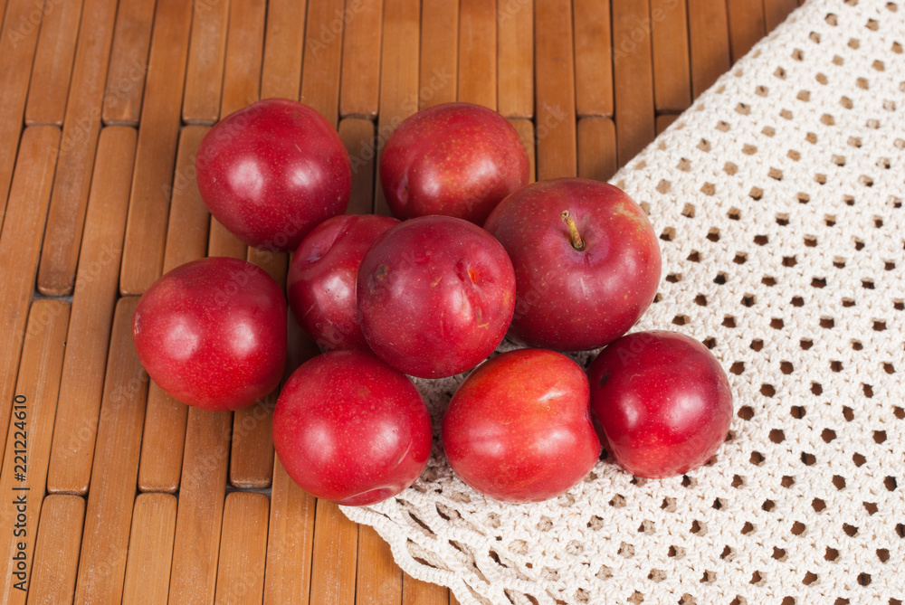red plum on the wooden background red plum on the wooden background
