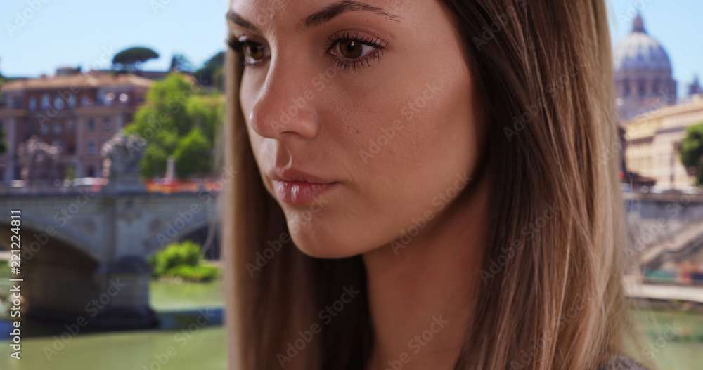 Close-up portrait of pretty brunette deep in thought outdoors in Rome, Italy Close-up portrait of pretty brunette deep in thought outdoors in Rome, Italy