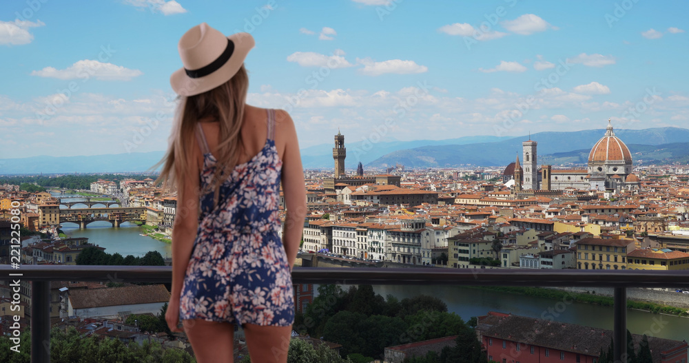 Rear shot of millennial girl in romper enjoying view of Florence cityscape