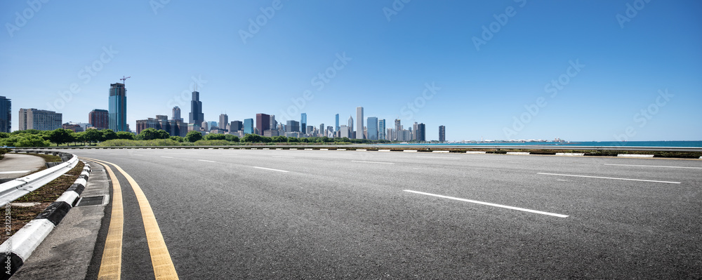 Naklejka premium asphalt highway with modern city in chicago