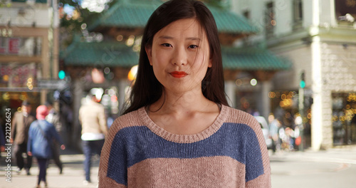 Photography Close up of cute female tourist in San Francisco Chinatown looking to side