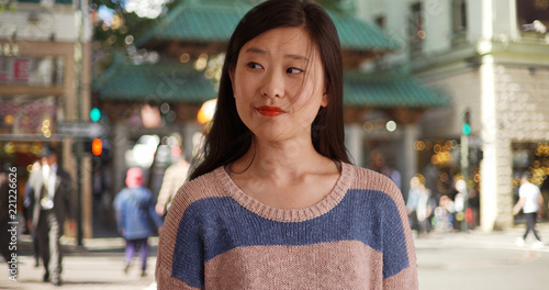 Close up of cute female tourist in San Francisco Chinatown looking to side