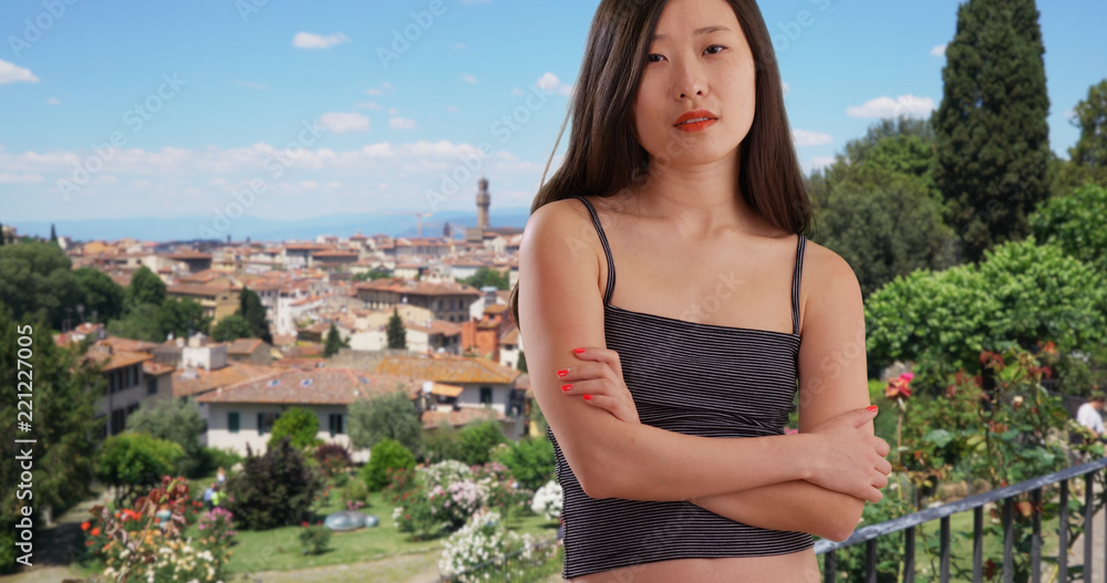 Fototapeta premium Close up of Asian millennial posing with arms crossed in Florence Italy