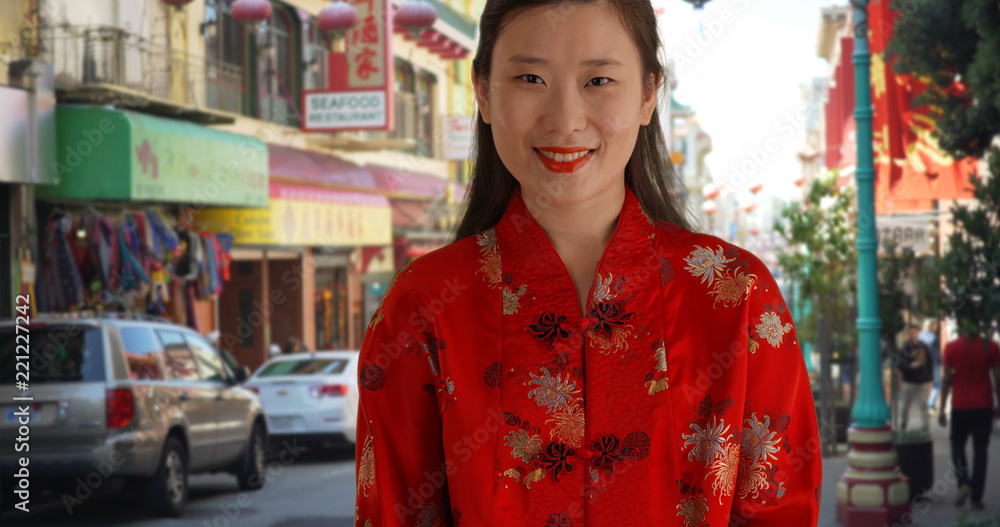 Close up of Asian millennial in traditional Chinese outfit in China Town