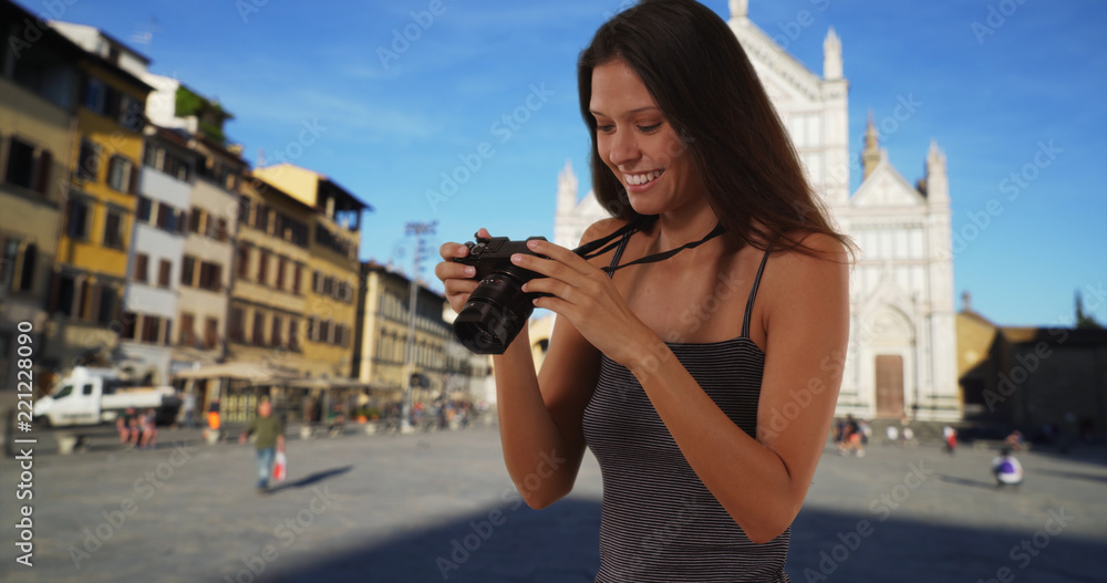 Beautiful tourist woman with dslr camera taking photo in Santa Croce Florence