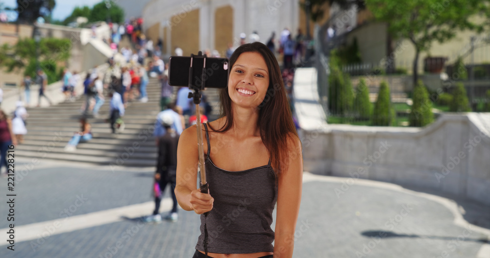 Cute millennial girl vacationing Rome taking silly selfies by the Spanish Steps