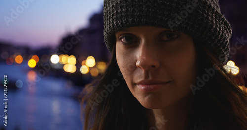 Dramatic close up portrait of woman tourist in Venice at night