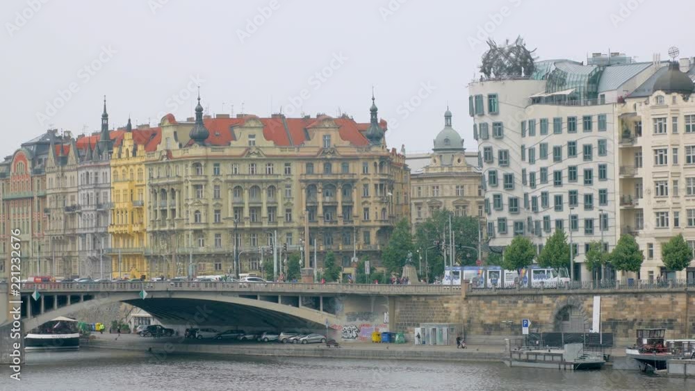 amazing architecture of Prague in quay of Vltava river, bright facades of buildings, in summer day amazing architecture of Prague in quay of Vltava river, bright facades of buildings, in summer day