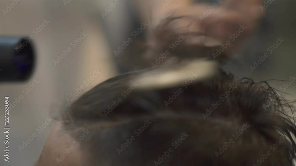 Male hairstyle after hair cut in barber shop. Styling with hair dryer. Close up male hairdo in salon. Barber using dryer in hairdressing salon. Male hairstyle after hair cut in barber shop. Styling with hair dryer. Close up male hairdo in salon. Barber using dryer in hairdressing salon.
