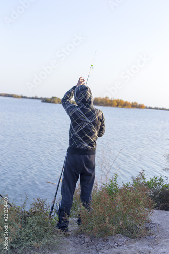 man is fishing on the lake