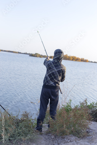 man is fishing on the lake