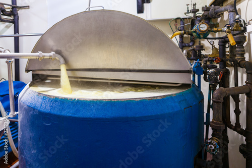 Vanilla Ice Cream Mixture Pumped into Large Industrial Ice Cream Making Tank