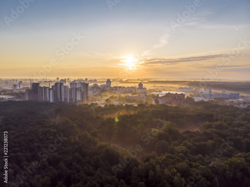 Fototapeta Naklejka Na Ścianę i Meble -  urban summer landscape in early morning with rising sun