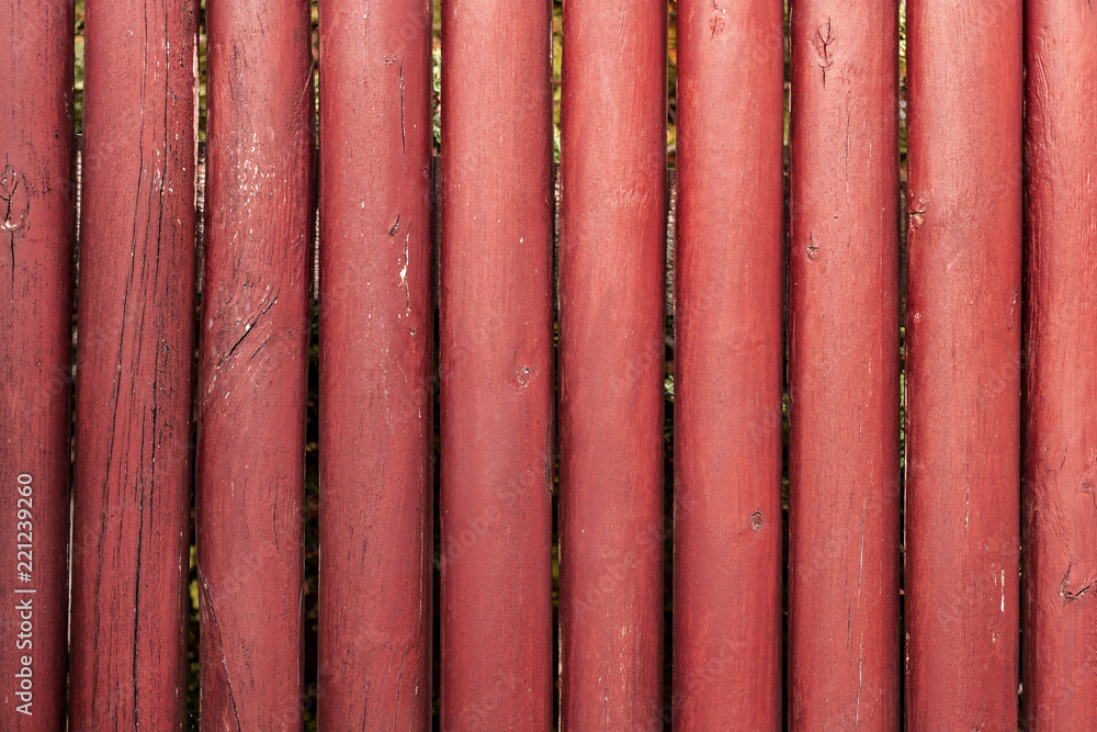 background, fence of red round sticks background, fence of red round sticks