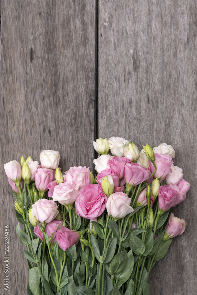 Beautiful bouquet of pink roses on wood background, outdoor