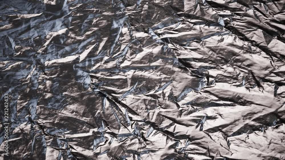 Crumpled, aluminium foil shining in the spotlight. Endless, abstract pattern. 4K Crumpled, aluminium foil shining in the spotlight. Endless, abstract pattern. 4K