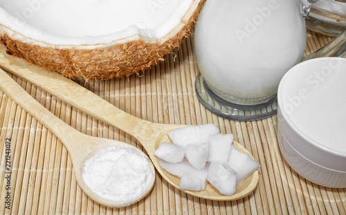 Coconut in cosmetology. Сream, balm, coconut milk. Skin, body and face care. Cosmetology. Nutrition and hydration. Homemade coconut products. Wooden spoons with coconut pulp and in powder.