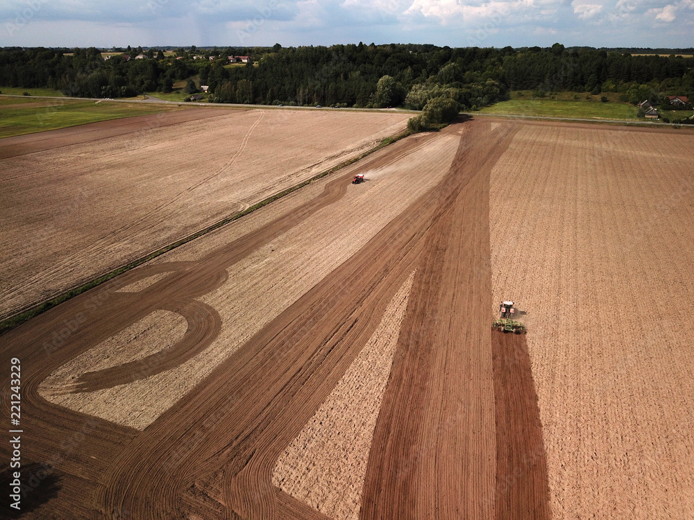 Fototapeta premium Aerial view of tractor on agricultural field
