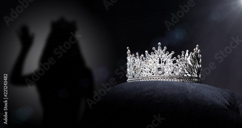 Fototapeta Naklejka Na Ścianę i Meble -  Diamond Silver Crown for Miss Pageant Beauty queen Contest, Crystal Tiara jewelry decorated gems stone and abstract dark background on black velvet fabric cloth, Macro photography copy space