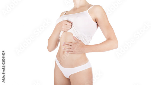 Slim tanned woman's body over gray background.